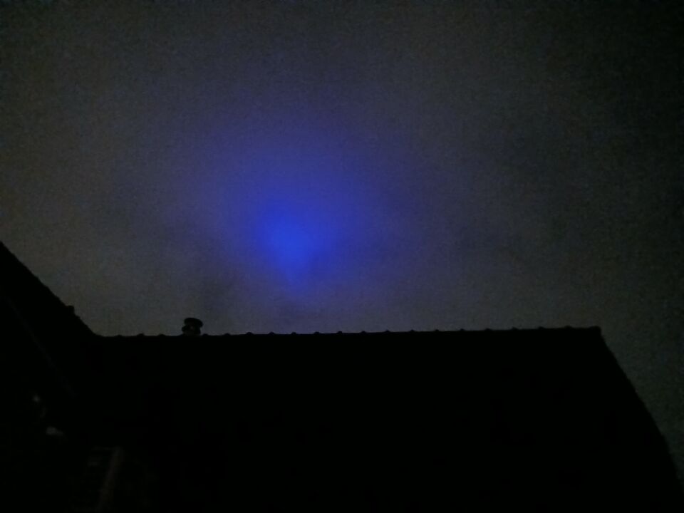 Blauwe gloed in of boven de bewolking dat zich verplaatste foto