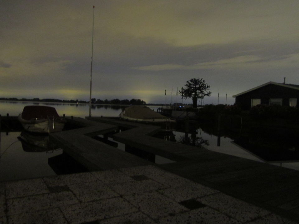 Van kleur veranderende (blauw->rood) draaiende lichtstaven laag boven het water foto